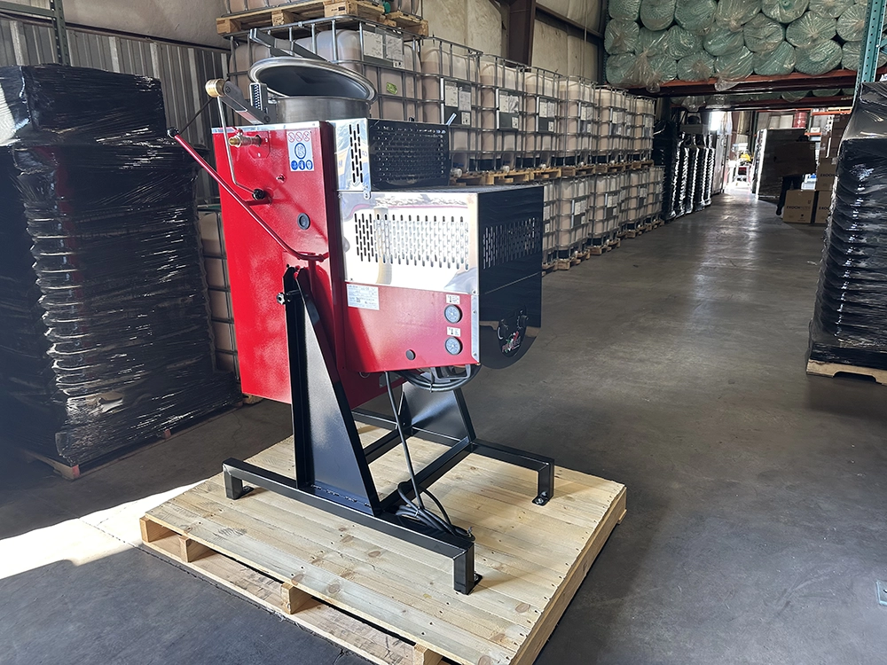 Angled side view of the Formeco Distiller DI 60 showing the control panel and part of the red housing, positioned on a wooden pallet.